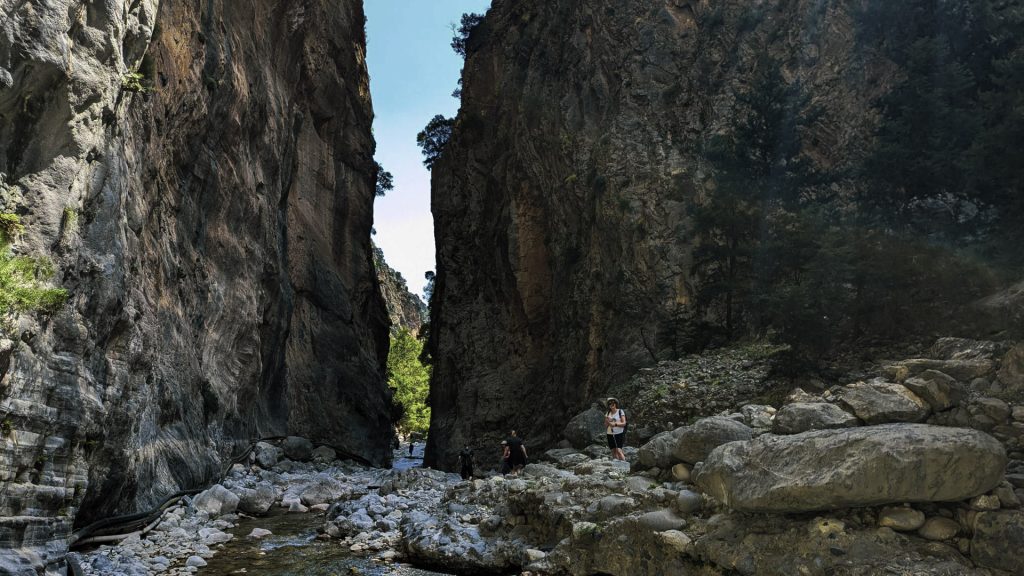 The Iron Gates of Samaria Gorge, where narrow limestone walls rise 300 meters high over a rocky path.