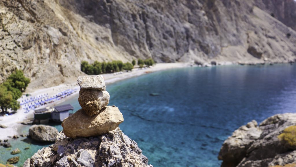 View from a hiking trail overlooking the stunning turquoise waters of Glyka Nera beach in Sfakia, Crete.