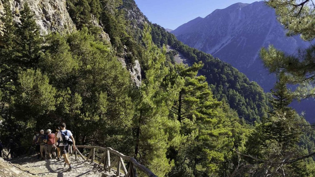Hikers descending the steep stone steps in Samaria National Park.