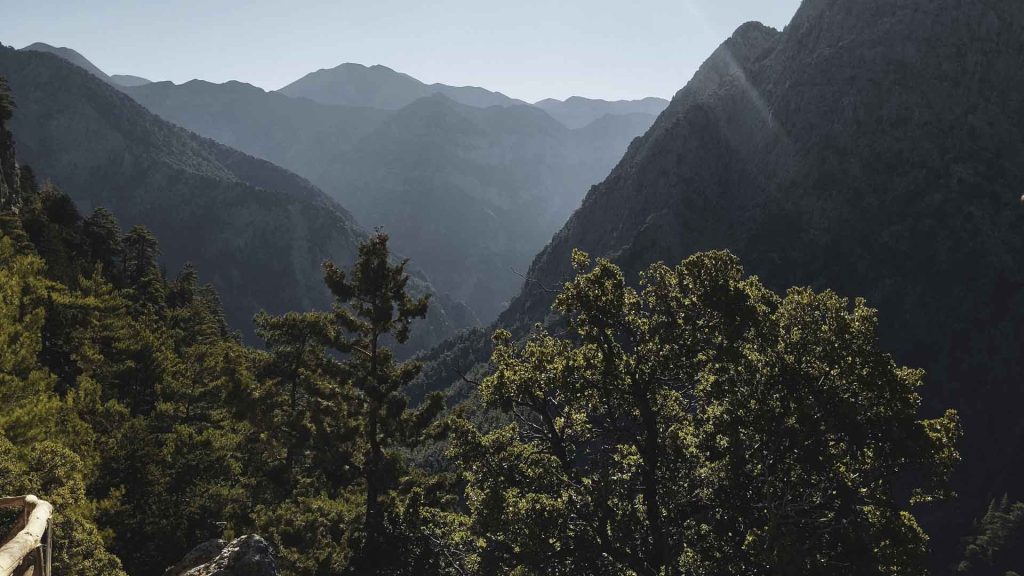 The dramatic descent begins at Xyloskalo (1,230m), offering a bird's-eye view of the White Mountains' rugged peaks.