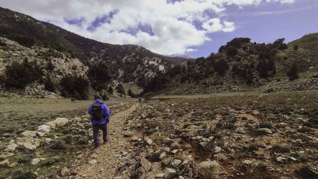 Hiker moving on the Chania trails network at heart of the Lefka Ori mountains in Chania, Crete. 